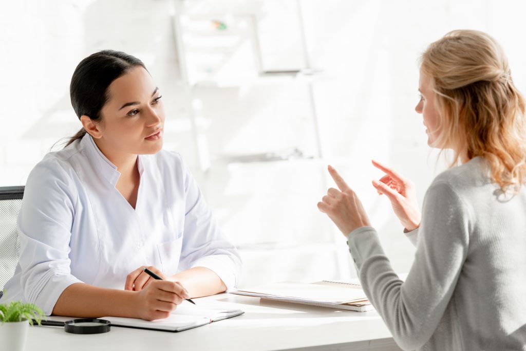 Healthcare professional engaging in a conversation with a patient during a consultation.