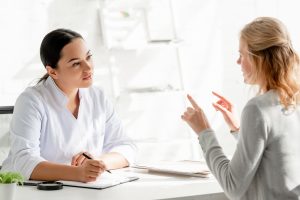 Healthcare professional engaging in a conversation with a patient during a consultation.