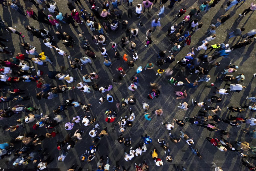 A top-down view of a large crowd of people gathered together, creating a bustling and energetic atmosphere